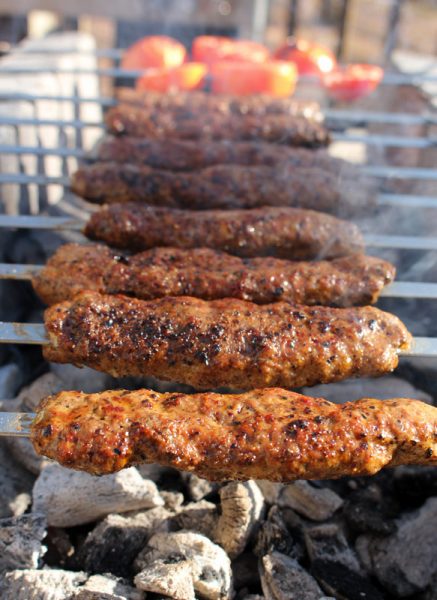 Image of Adana kebabs finishing on the grill