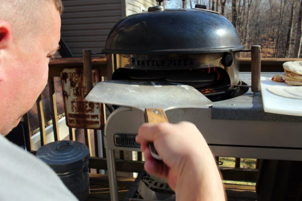 Image of James putting pita on pizza stone